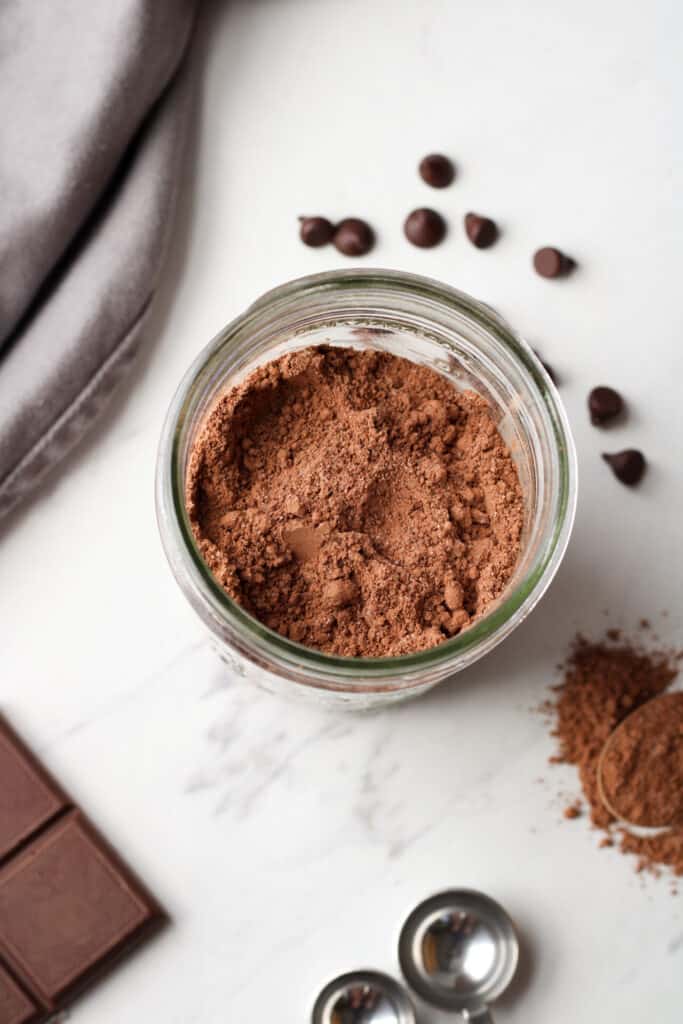 Close up on diy hot chocolate mix recipe in mason jar. 