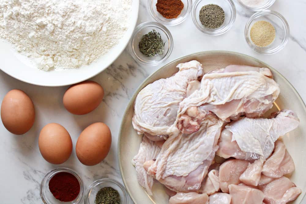 Ingredients for fried chicken on a table.