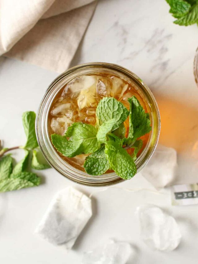 Overhead view of iced mint green tea on a counter with ice.