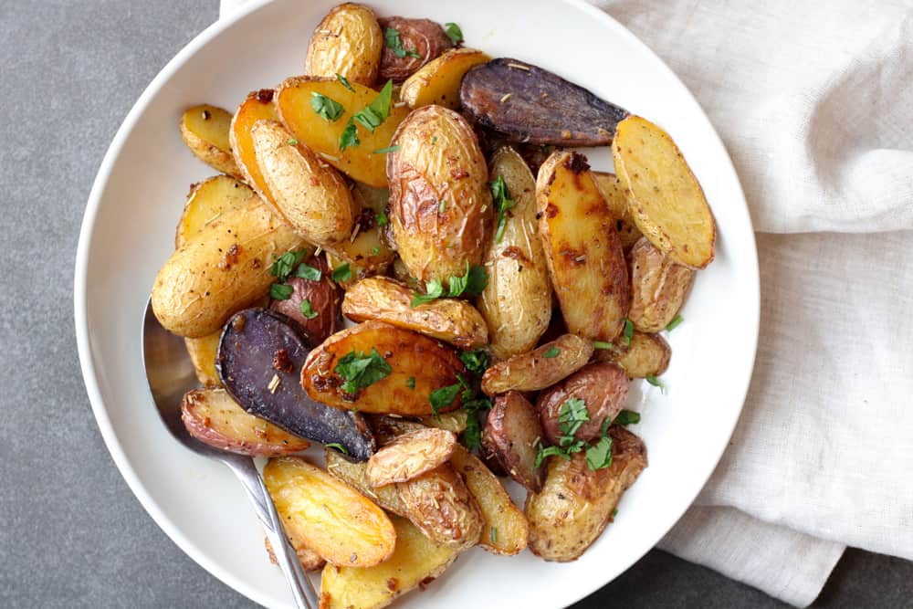 Overhead view of roasted potatoes on a plate.