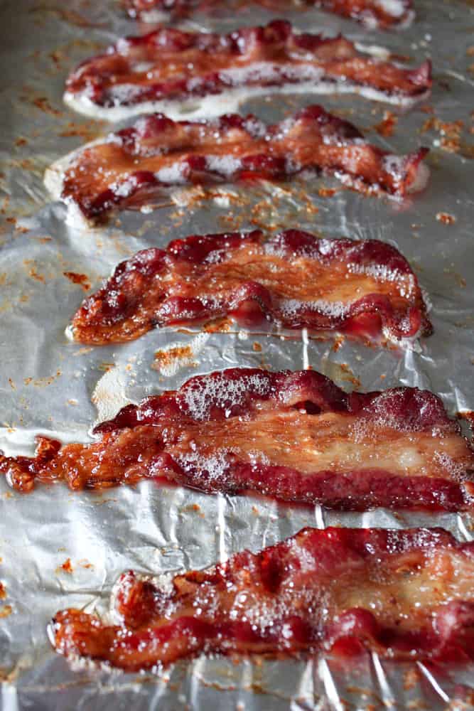 Crispy baked beef bacon on a sheet pan with aluminum foil. 