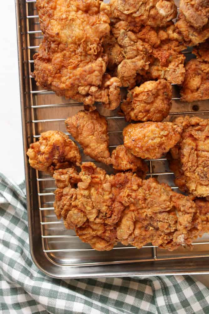 Crispy fried chicken on a wire rack.