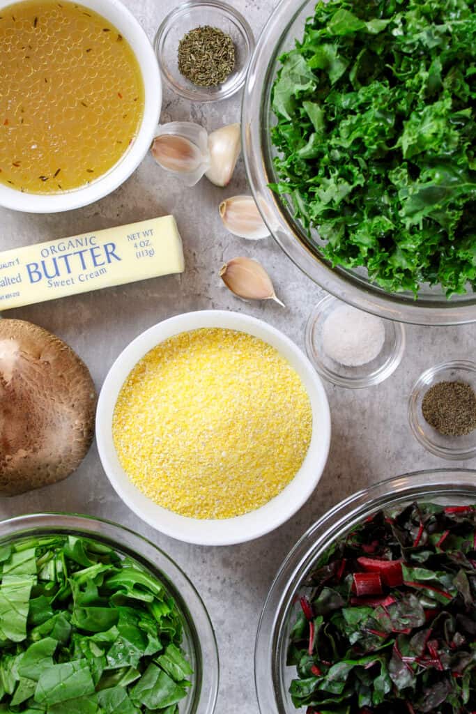 Creamy polenta with spinach and mushrooms ingredients on a table.