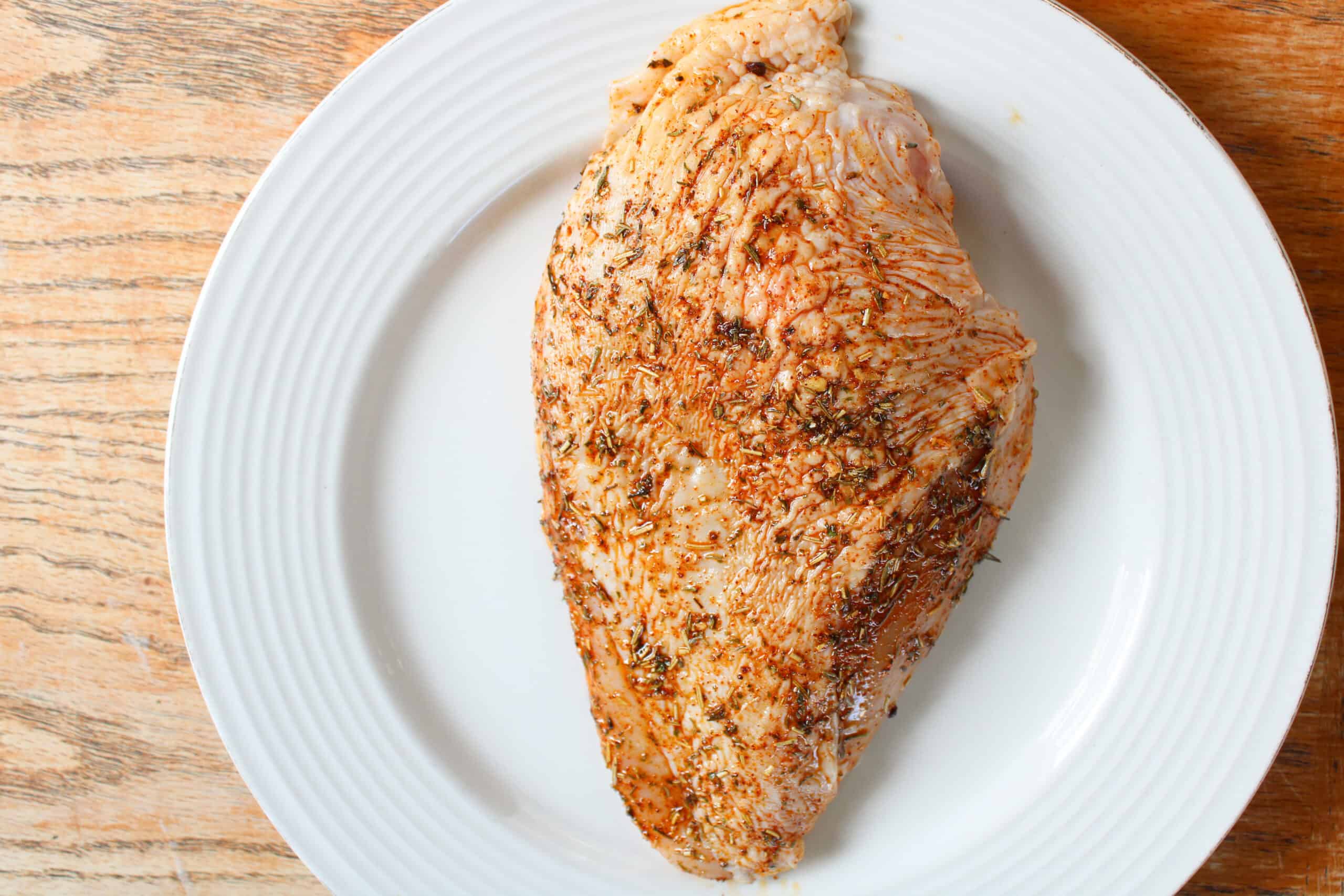 Close up on chicken breast with homemade chicken seasoning.