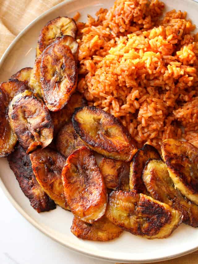 Fried plantains with Jollof rice on plate.
