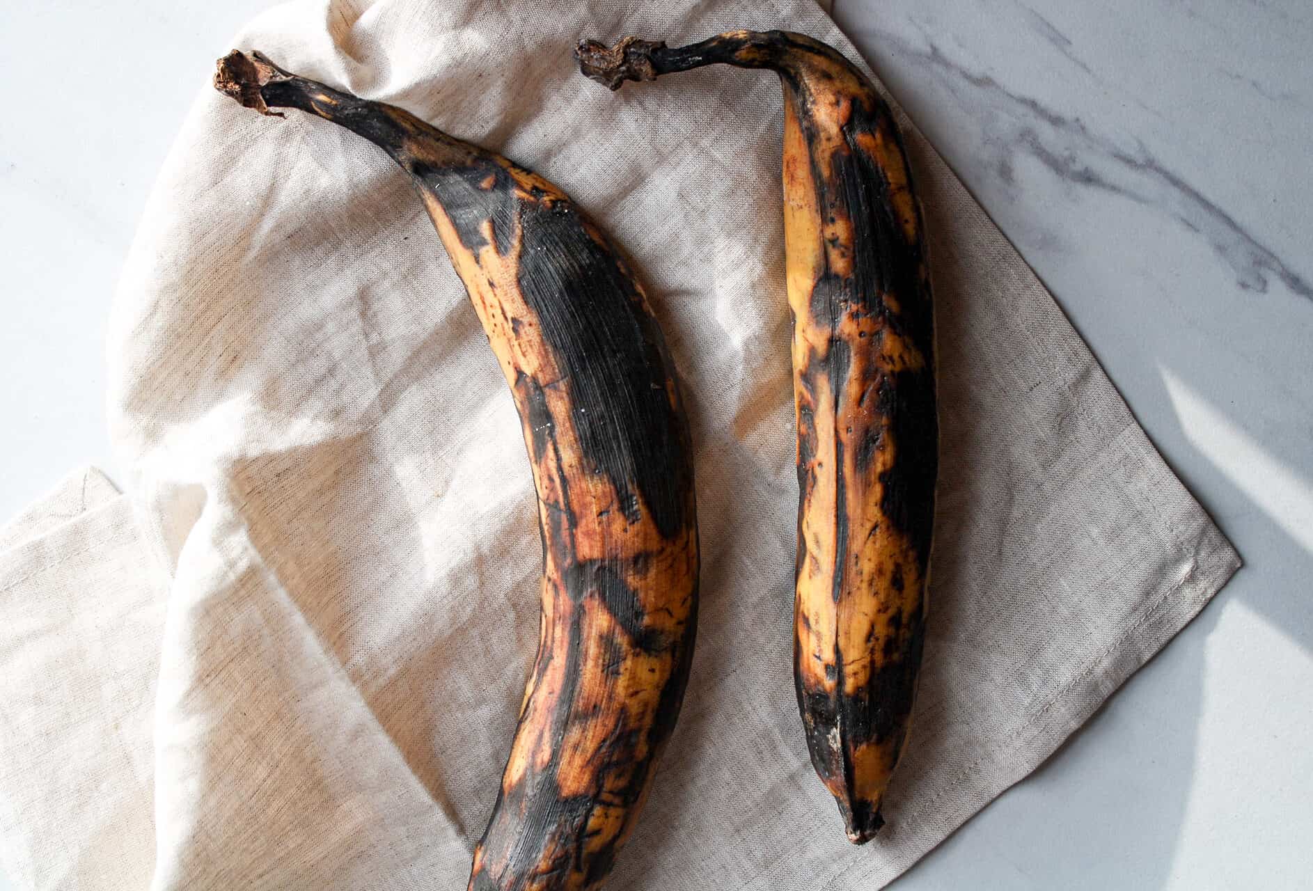 Whole plantains on a counter.
