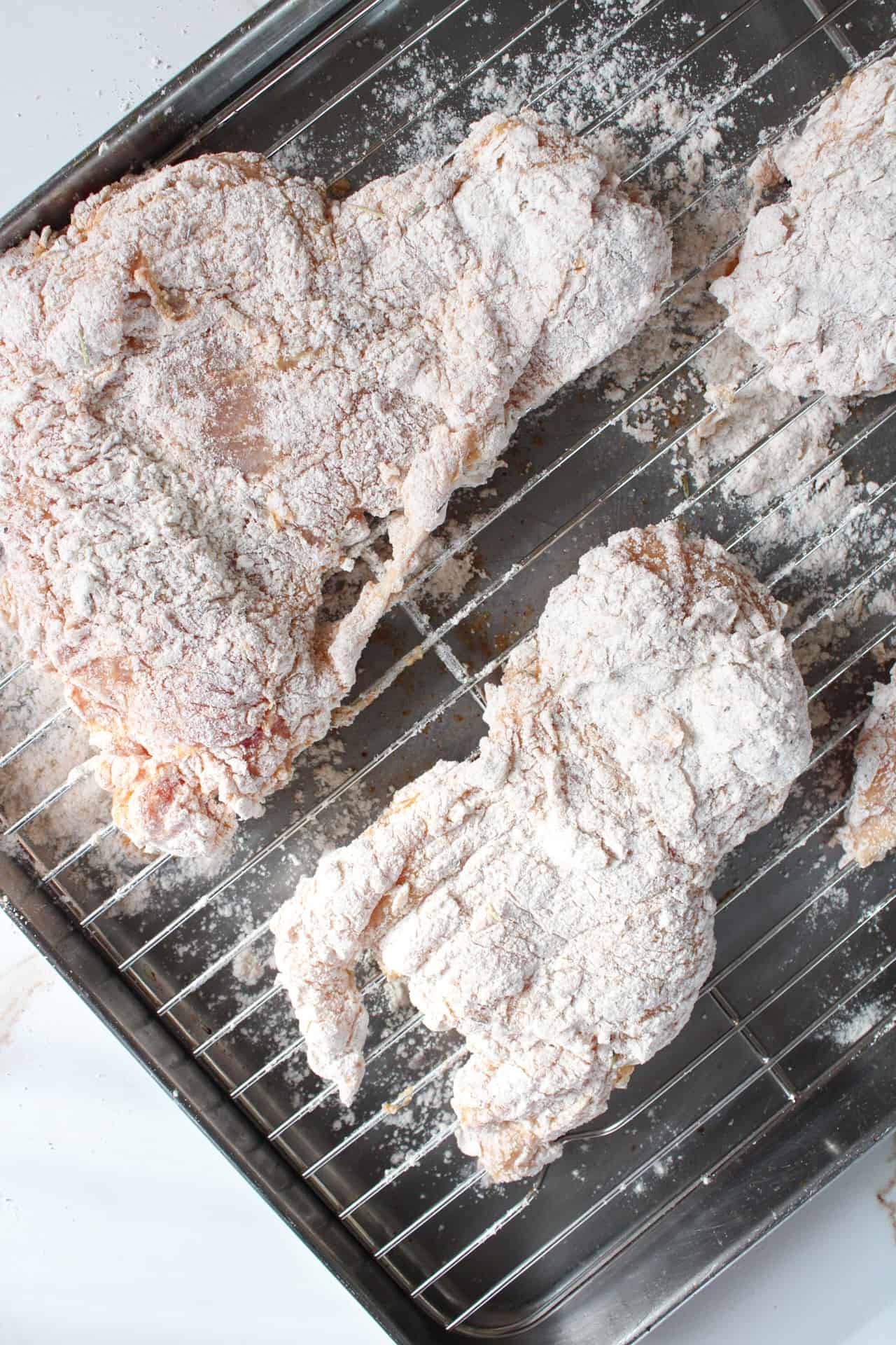 Battered chicken on wire rack.