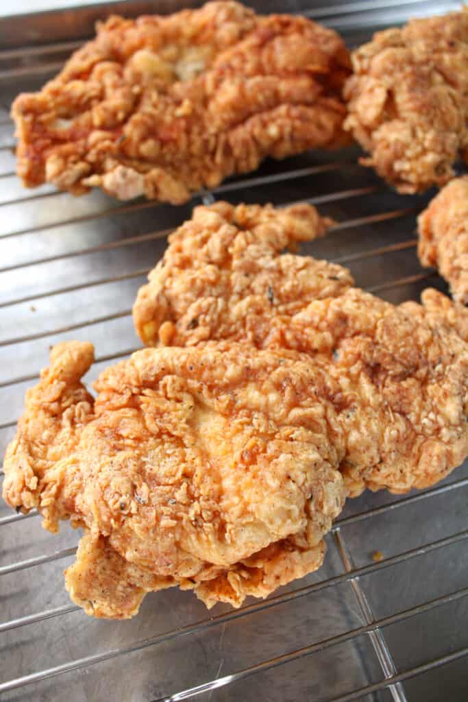 Close up on crispy dairy free chicken fried chicken on a wire rack.
