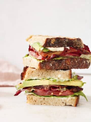 Side view of a stack of blt sandwiches.
