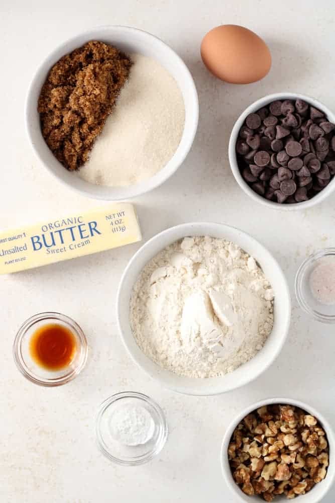 Overhead view of chocolate chip cookie ingredients on a table. 