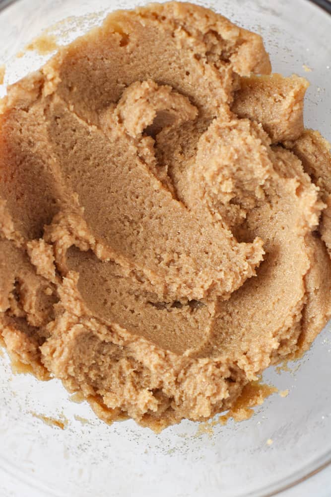 Close up on butter and sugar creamed together in a bowl.