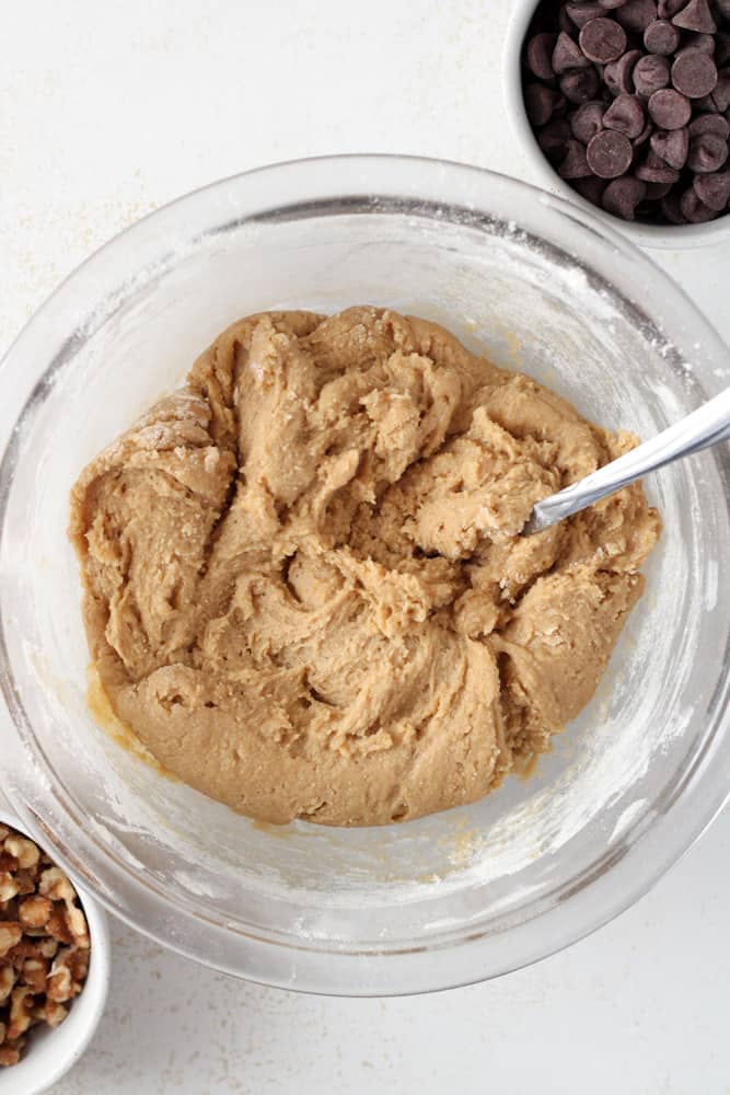 Cookie batter dough in a bowl with a spoon.