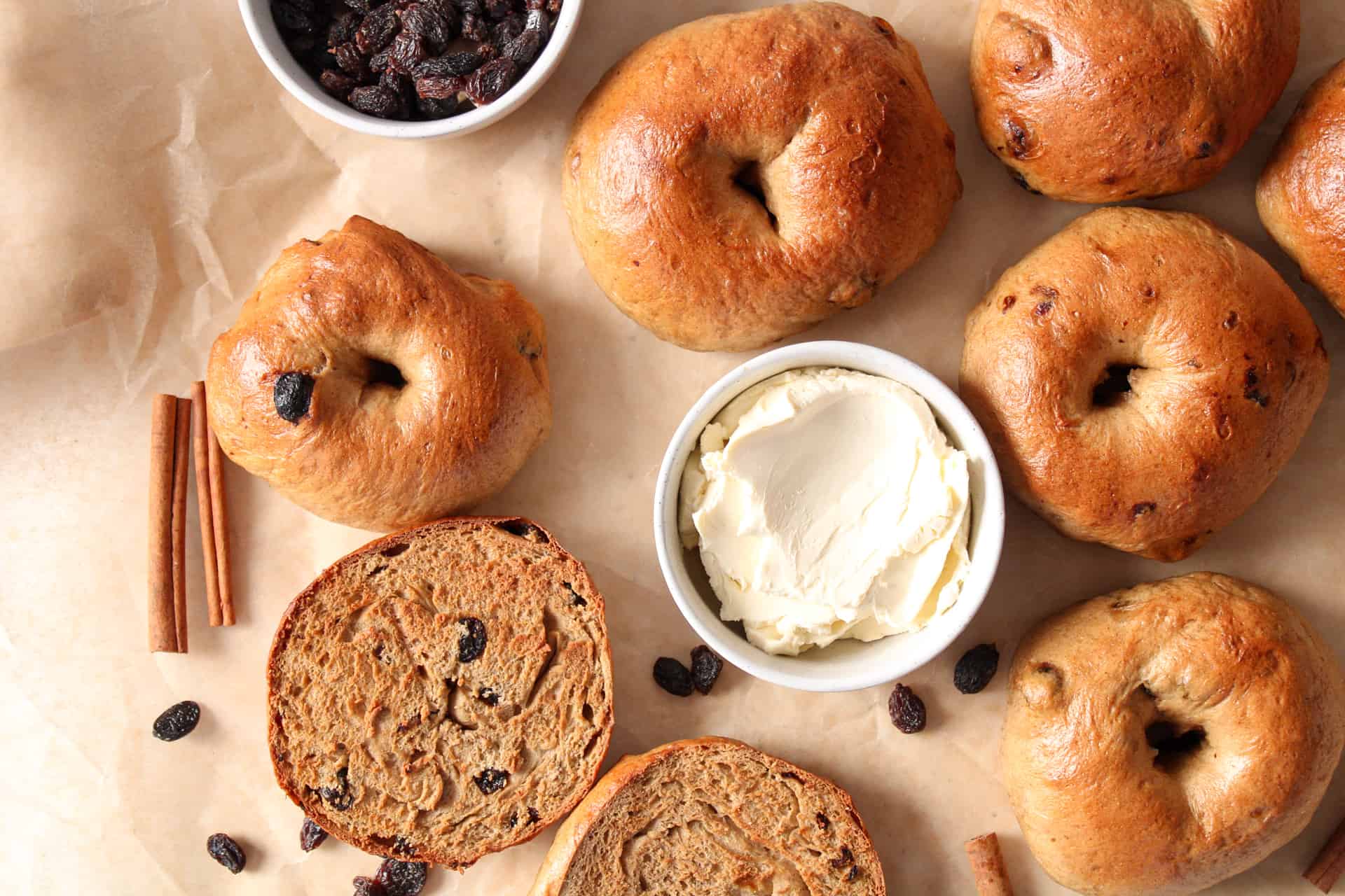 Overview of cinnamon raisin bagels on a table.