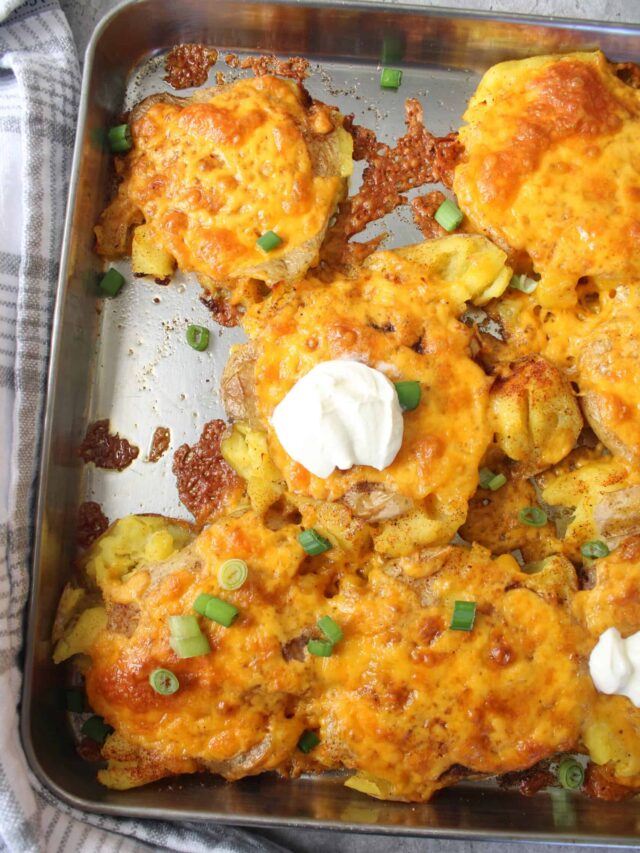 Cheesy smashed potatoes with a dollop of sour cream.