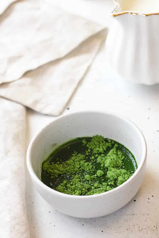 Matcha with water in a small bowl.