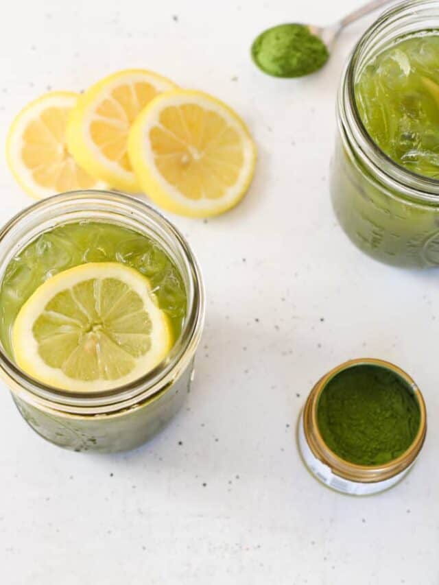 3/4 view of iced matcha lemonade with lemon slices.