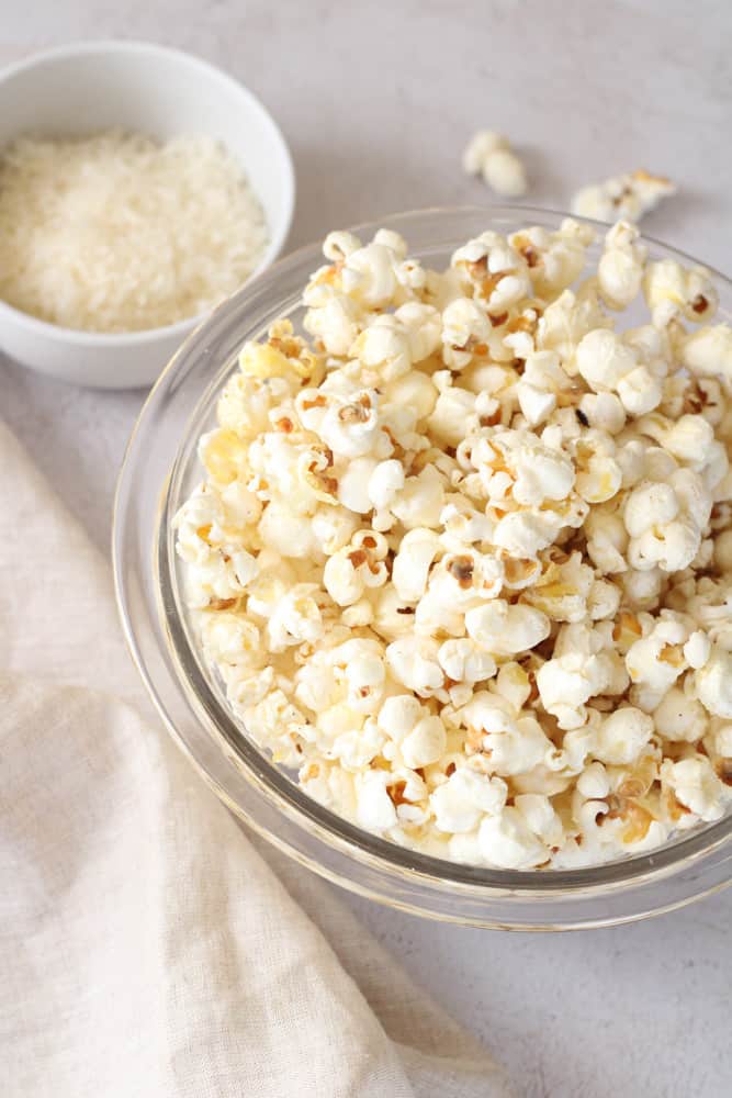 ¾ view of a bowl of parmesan cheese popcorn.