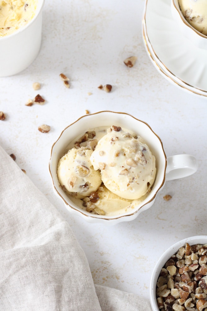 Overhead image of black walnut ice cream in a tea cup. 