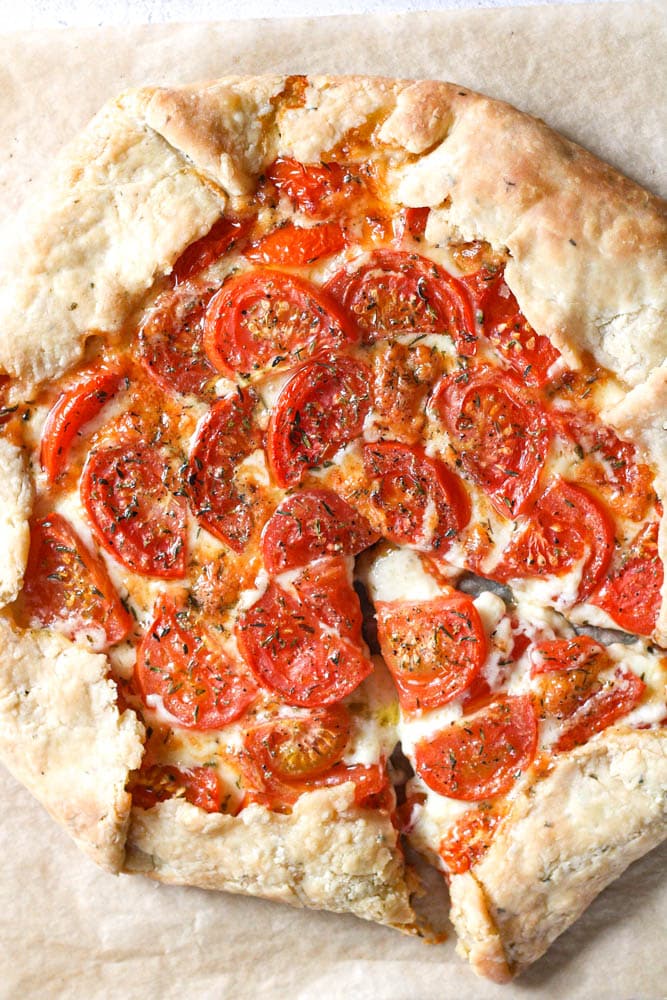 Overhead shot of a baked savory galette on parchment paper.