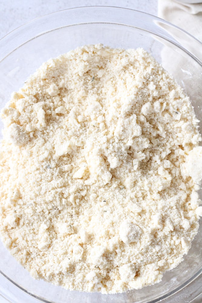 Flour mixed with butter in a large mixing bowl.