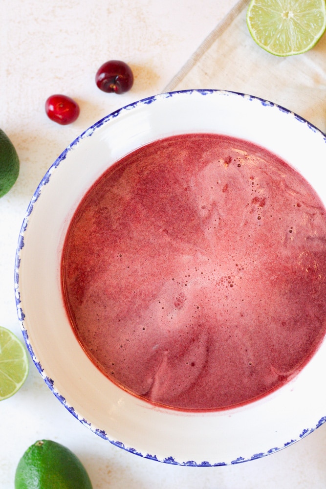 Cherry limeade concentrate in a large bowl.