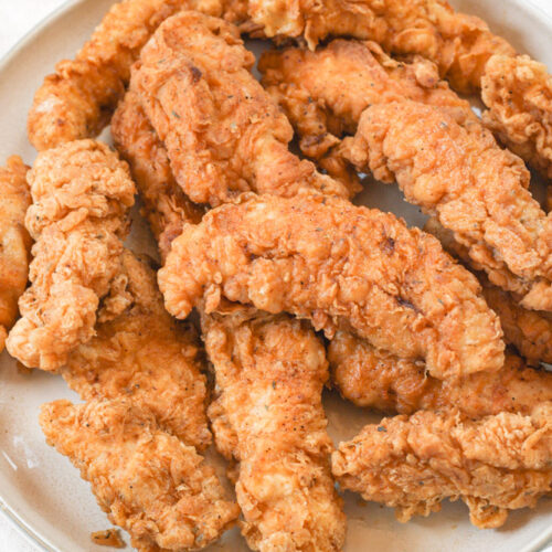 Plate full of fried chicken.