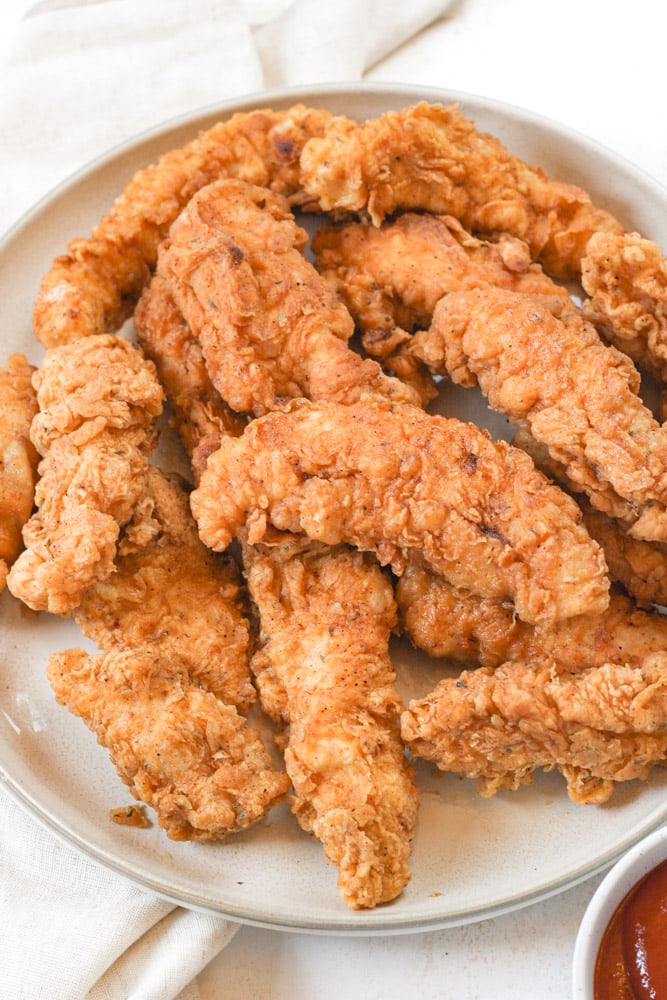 Plate full of fried chicken.