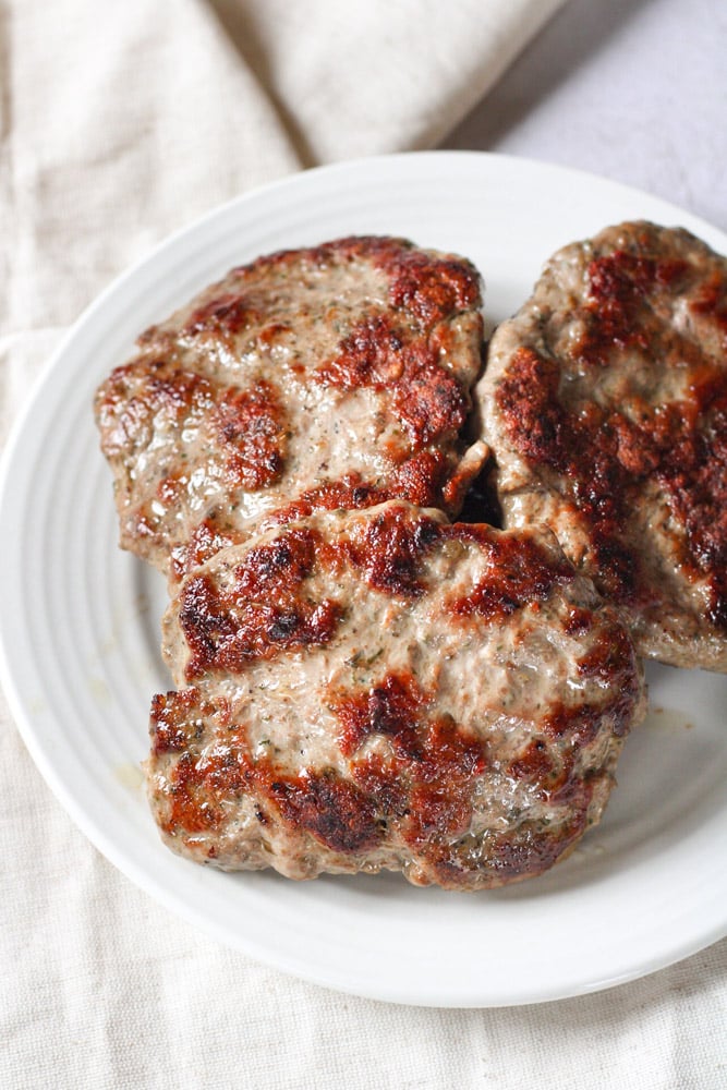 Close up image of lamb breakfast sausages on a plate.