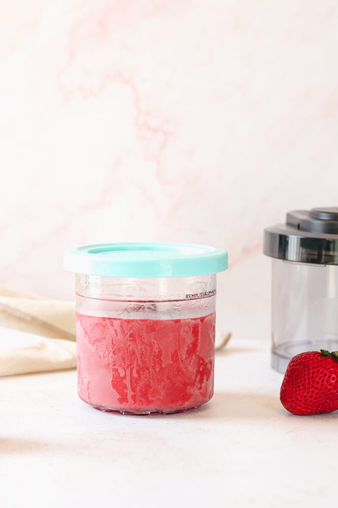 Side view of frozen sorbet in the ninja creami pint container.