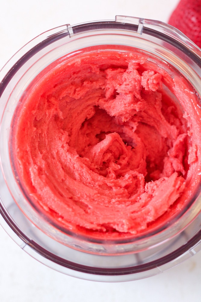 Close up image of blended sorbet in the ninja creami outer bowl.