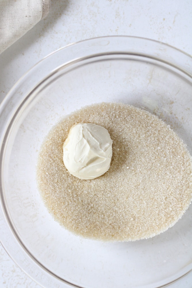 Close up image of cane sugar in a bowl with cream cheese.
