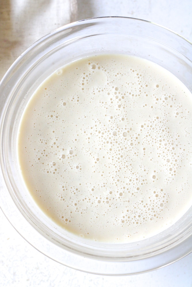 Frothy vanilla ice cream base in a bowl.