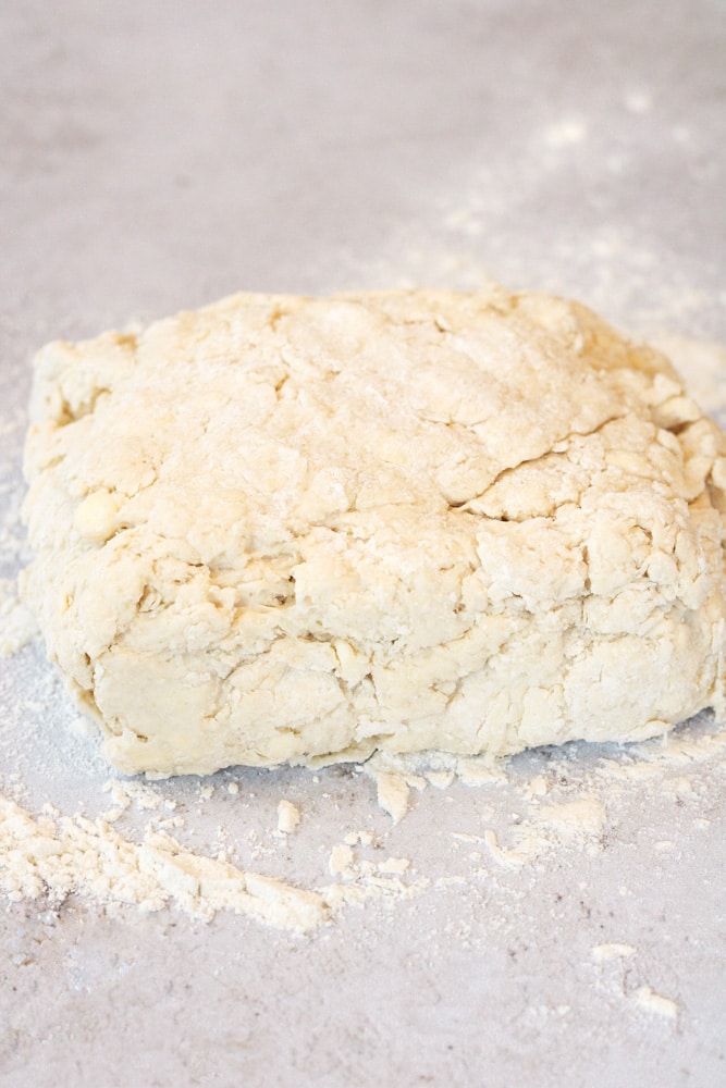 Folded biscuit dough on a table.