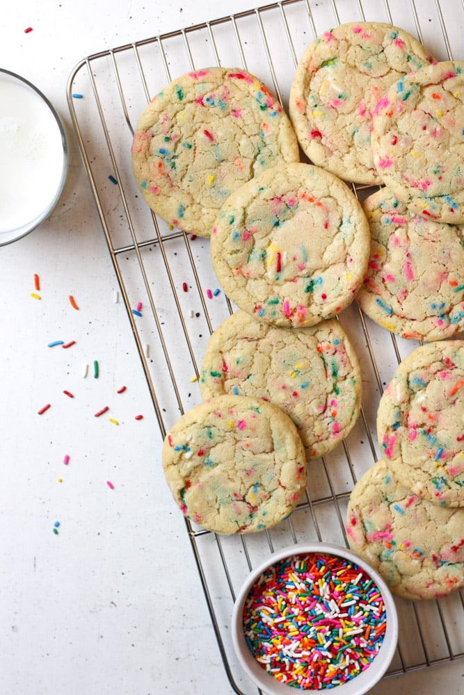 Overhead image of sprinkle cookies on a wire rack.