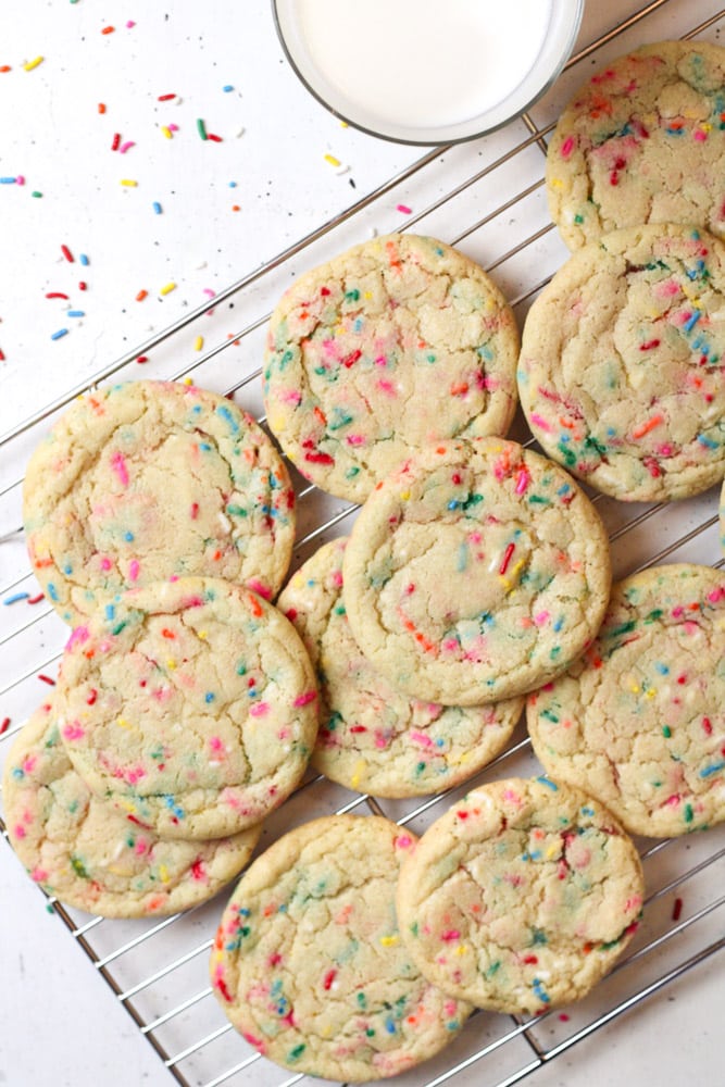 Overhead image of sprinkle cookies on a wire rack.