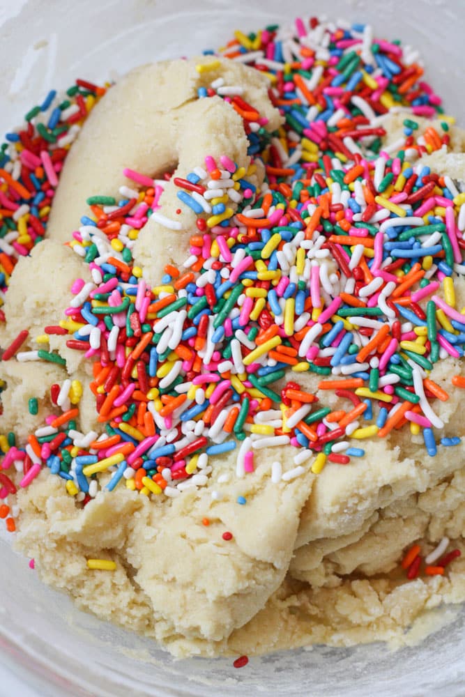 Sugar cookie dough with rainbow sprinkles on top.