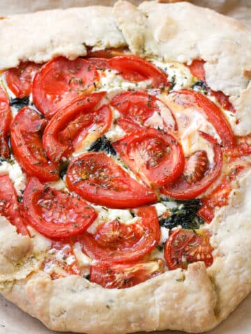 Close up view of the side of a tomato tart.