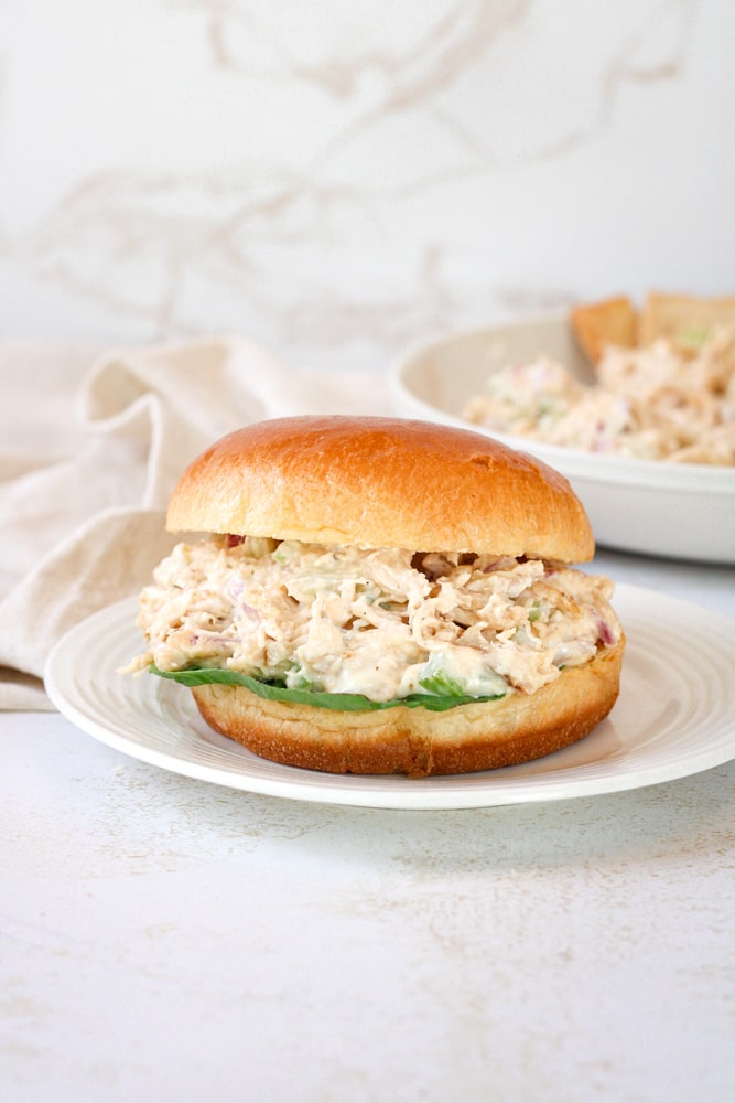 Side view of chicken salad sandwich with lettuce.