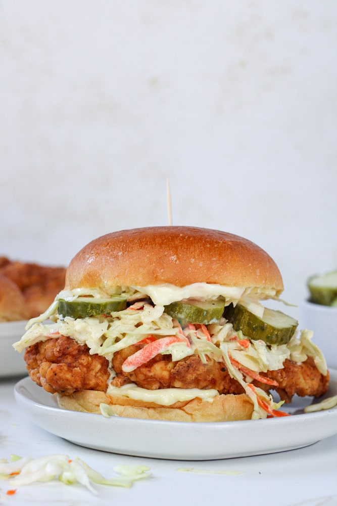 Side view of chicken sandwich with pickles.