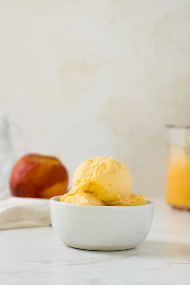 Scoops of peach sorbet in a bowl.