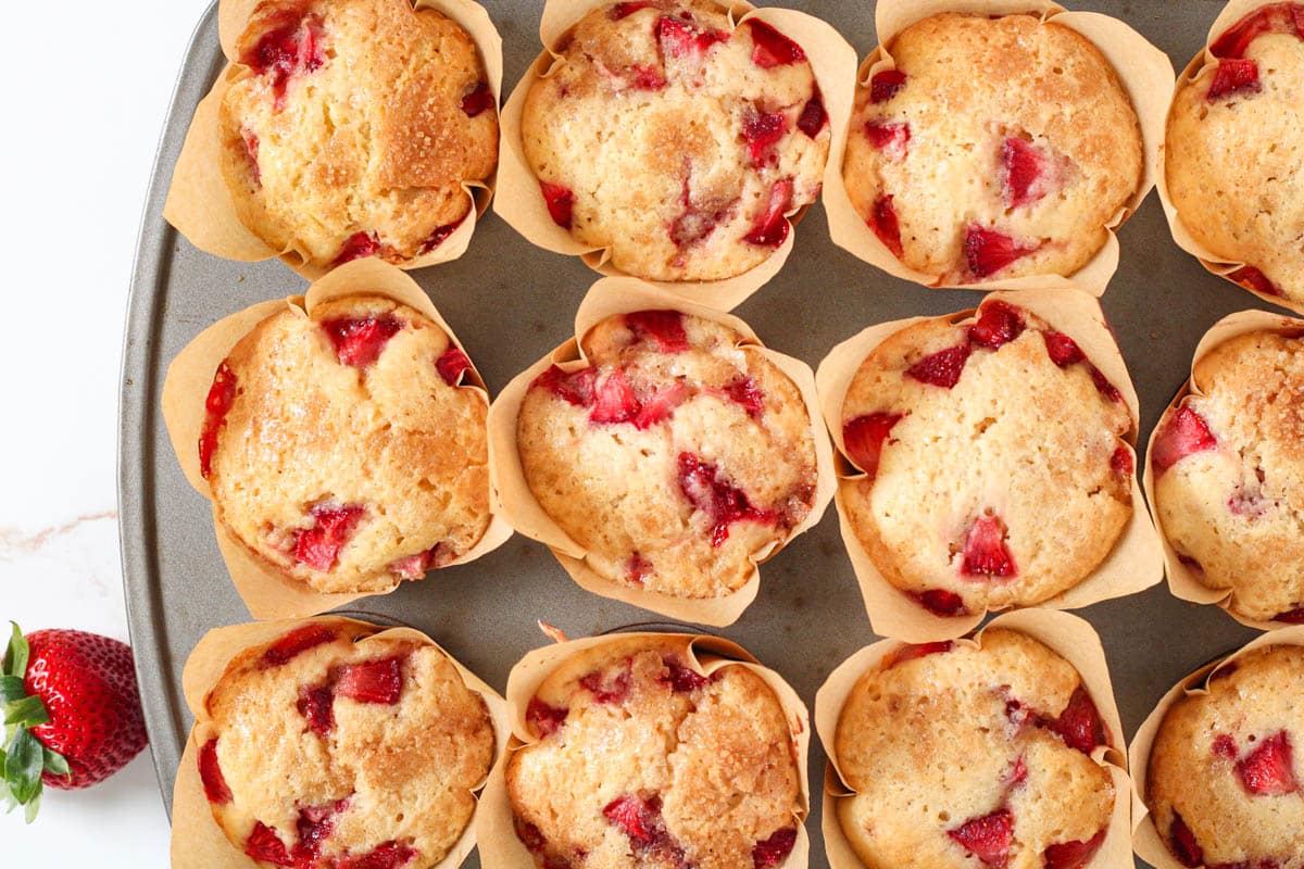 Overhead image of baked strawberry muffins in a muffin pan.