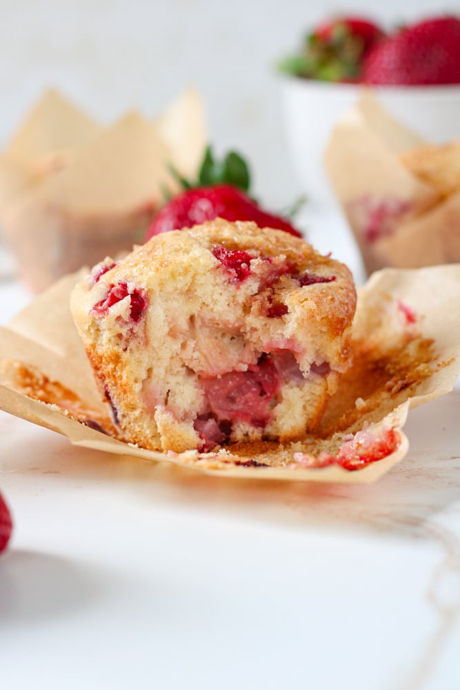 Side view of a muffin with a bite taken out of it.