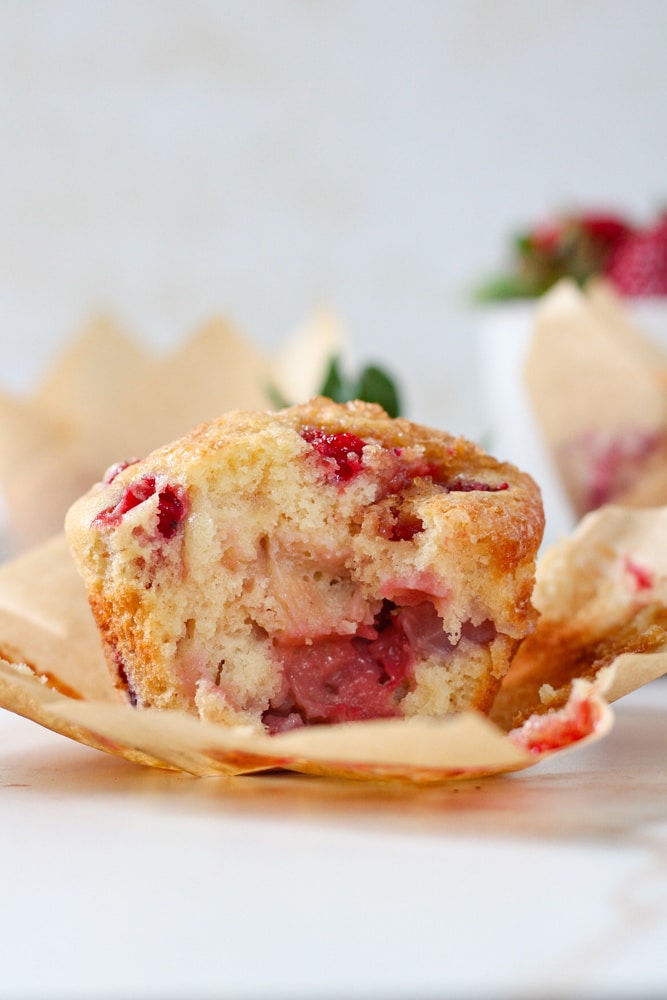Side view of a muffin with a bite taken out of it.