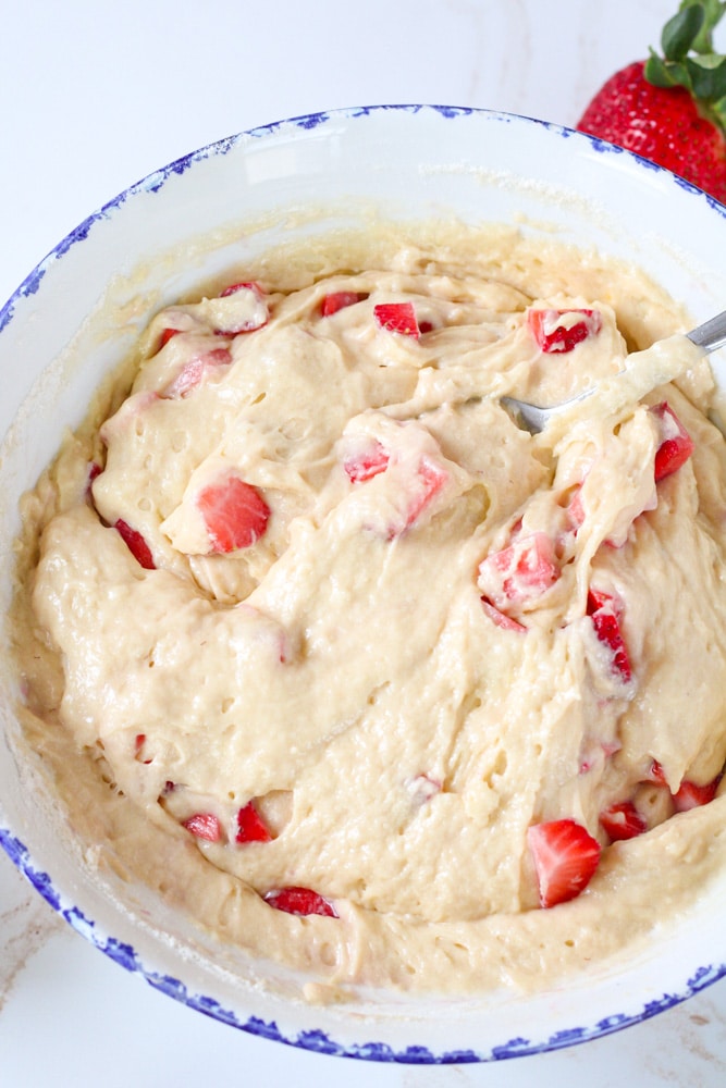 Overhead image of strawberry muffin batter in mixing bowl.