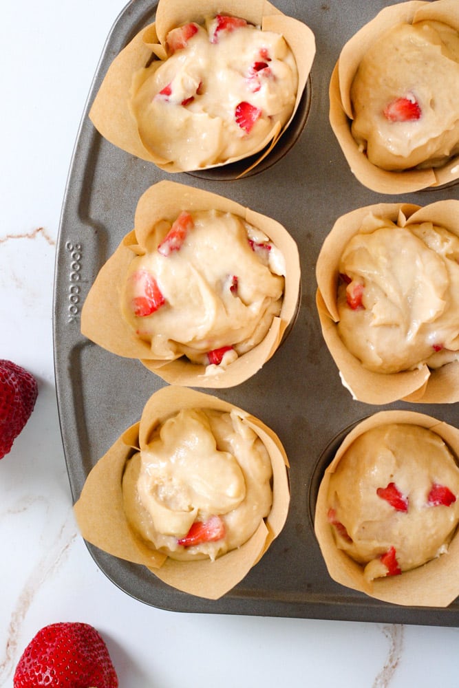 Strawberry muffin batter in muffin liners.