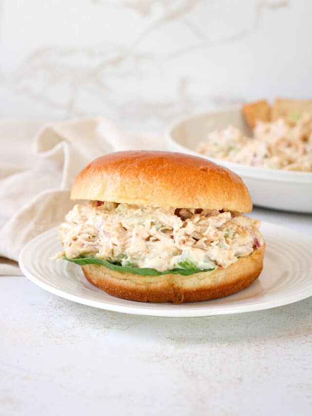 Side view of chicken salad sandwich with lettuce.