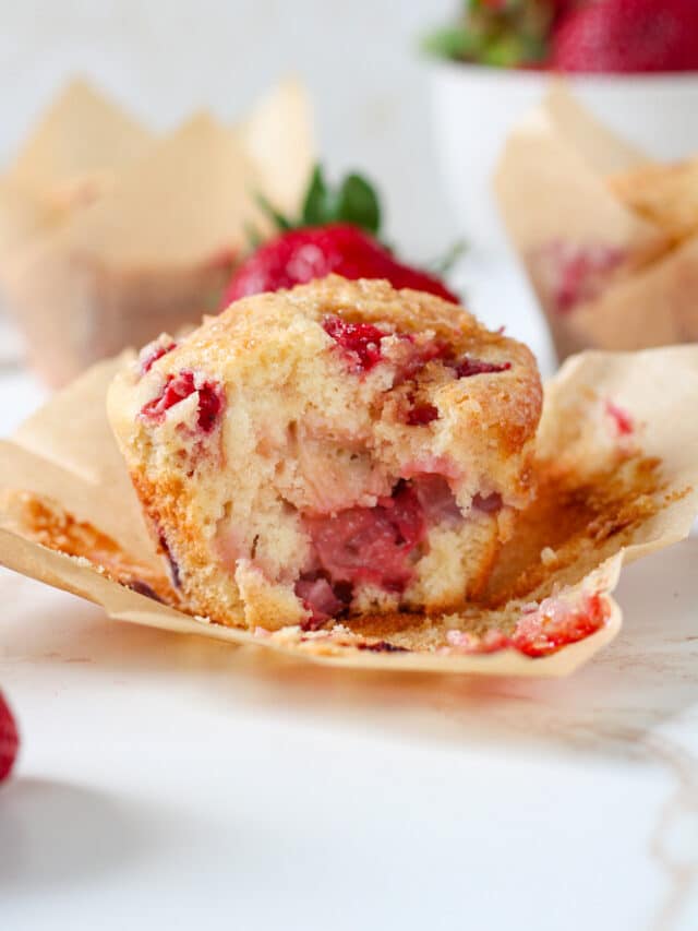 Side view of a muffin with a bite taken out of it.