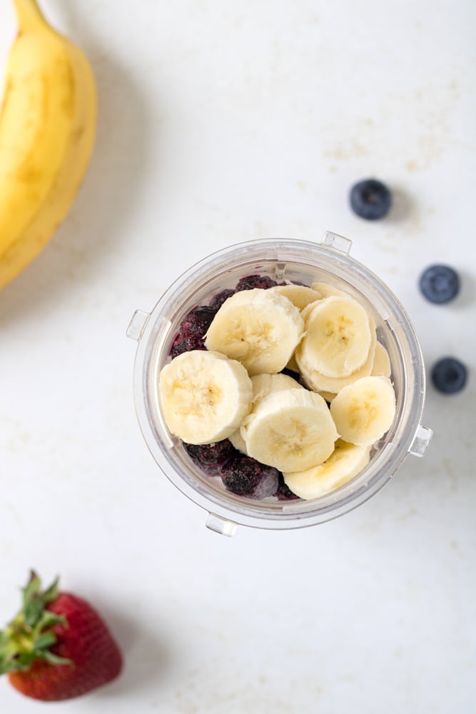 Blueberry smoothie ingredients in a blender.