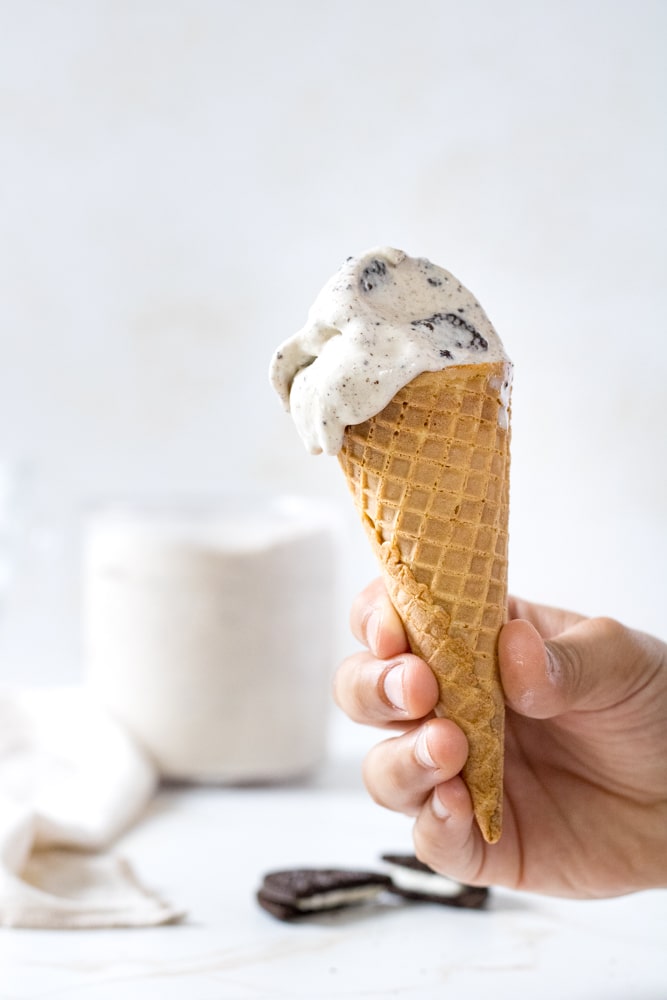 Close up image of child's hand holding ice cream cone.