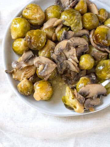 3/4 image of roasted brussels sprouts on a plate.